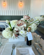 Brisbane wedding reception table with beige and white and orchid floral arrangements