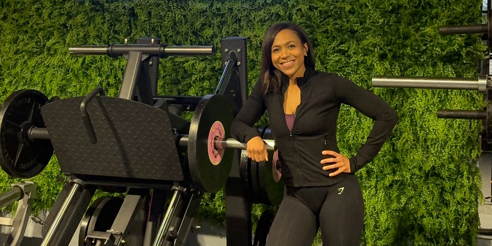 Certified personal trainer standing by gym equipment