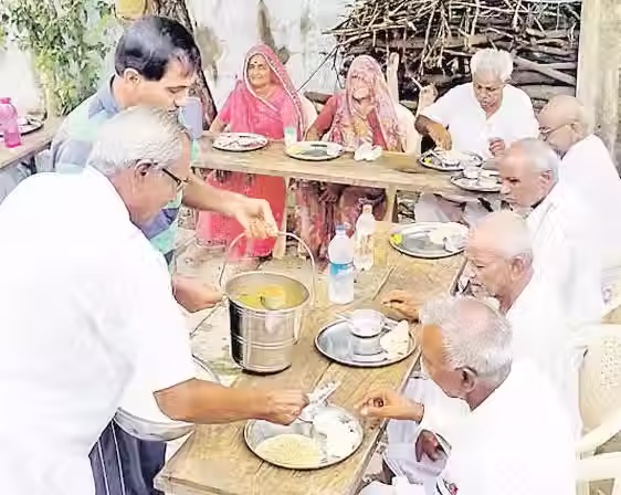 सौर ऊर्जा से चलने वाले एसी हॉल में खाना बनाने और साथ मिलकर खाना बांटने के लिए एकत्रित होने वाले बुजुर्ग ग्रामीण भारत की बढ़ती उम्र की आबादी की चुनौतियों से निपटने के लिए जगह और समाधान बनाने में शहरों को रास्ता दिखा रहे हैं। स्रोत: चंदनकी गांव में बुजुर्गों के लिए सामुदायिक रसोई