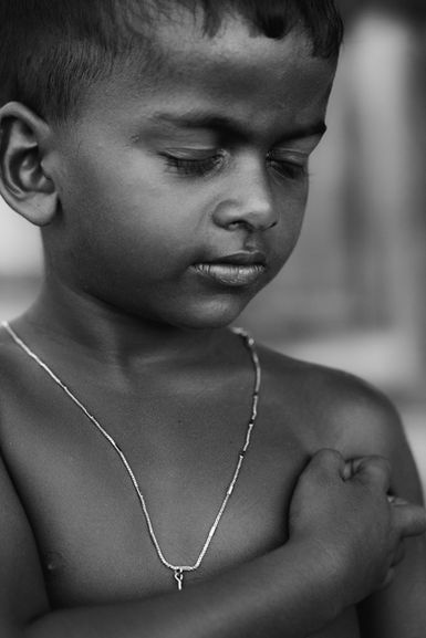 Black & white portrait of a young boy from Negombo beach. Natural light