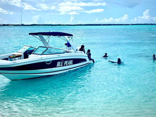 Guests swimming beside a private charter boat