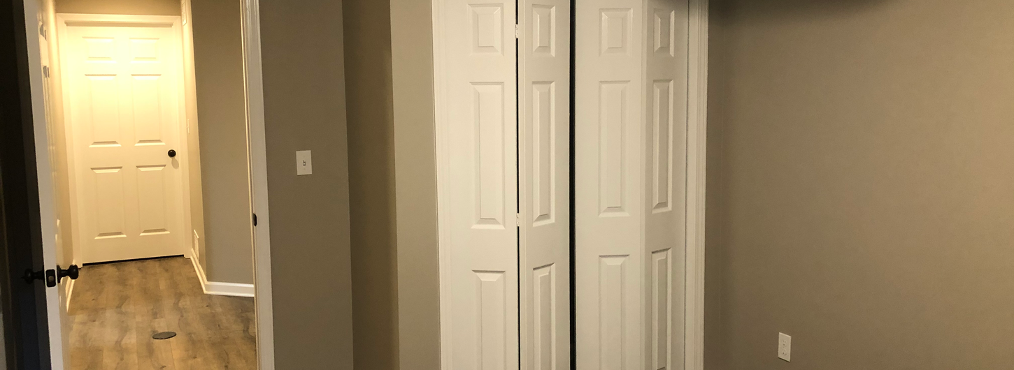 Expert basement remodeling progress in Leawood KS - painted walls, white doors, and trim details by (BDS) Brian's Drywall Services