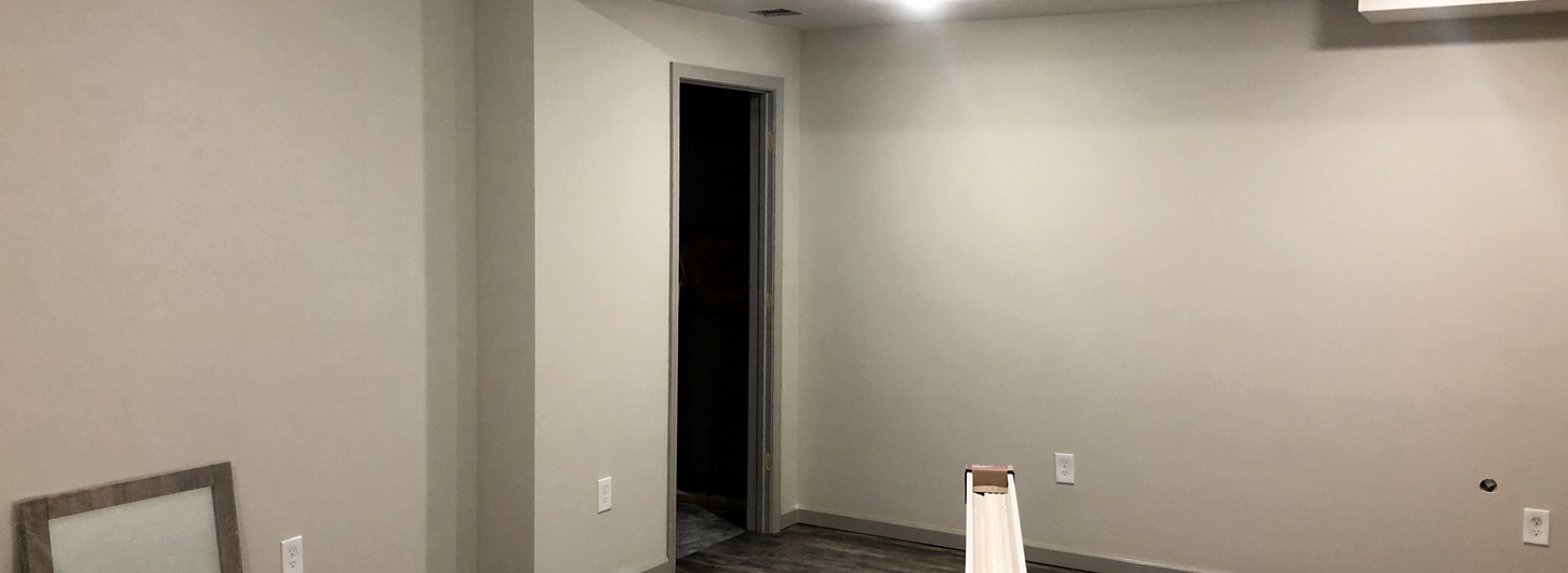 Basement renovation progress, freshly painted walls and flooring completion by (BDS) Brian's Drywall Services in Lee's Summit MO