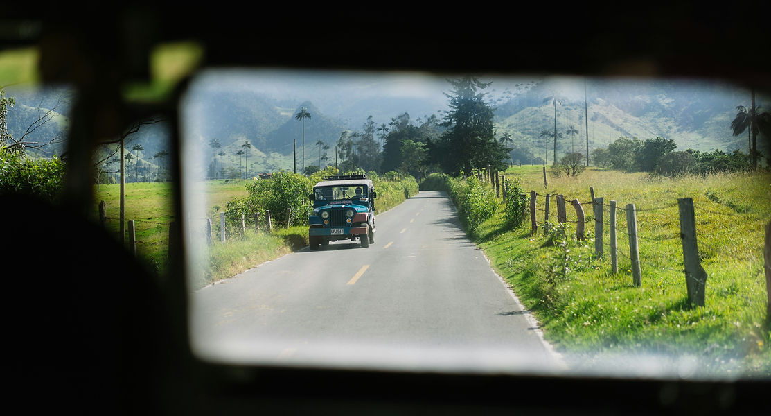 Bomarzo hallway with painting on each wall and a window at the end