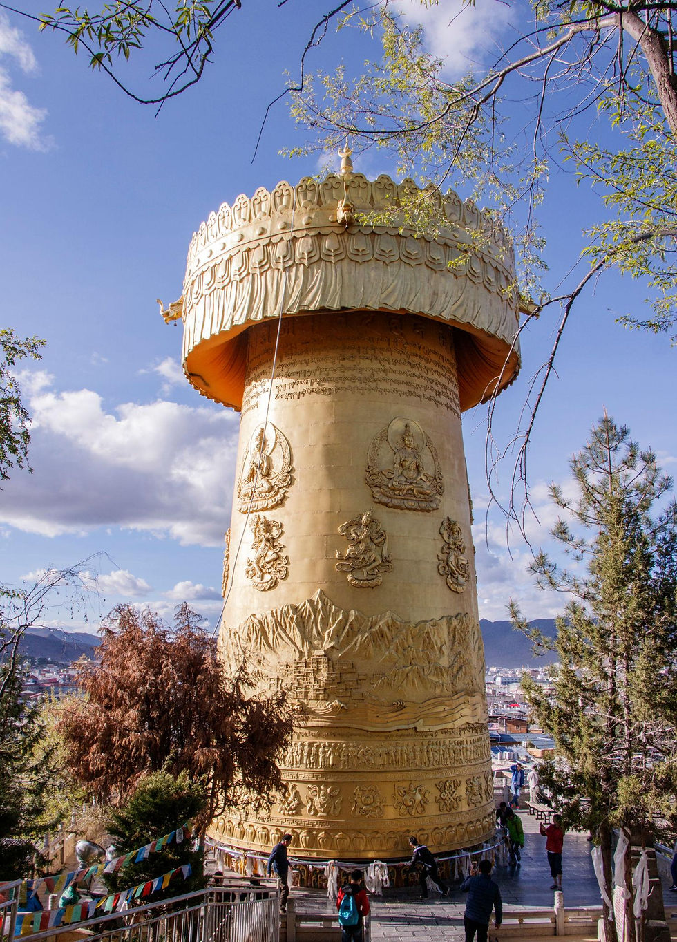 High angle view of the Giant Prayer Wheel in Dukezong Ancient Town with mountains in the background