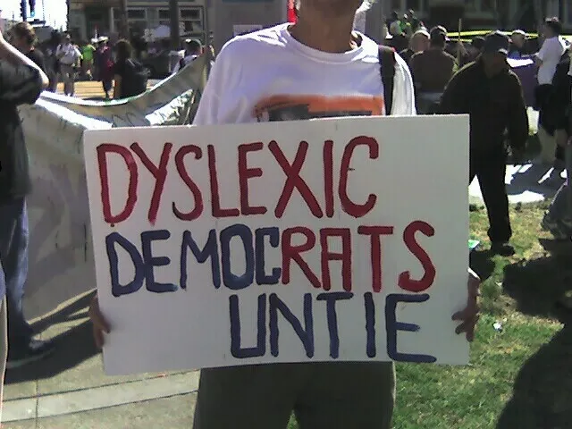 Someone holding a sign outside saying Dyslexic Democrats Untie