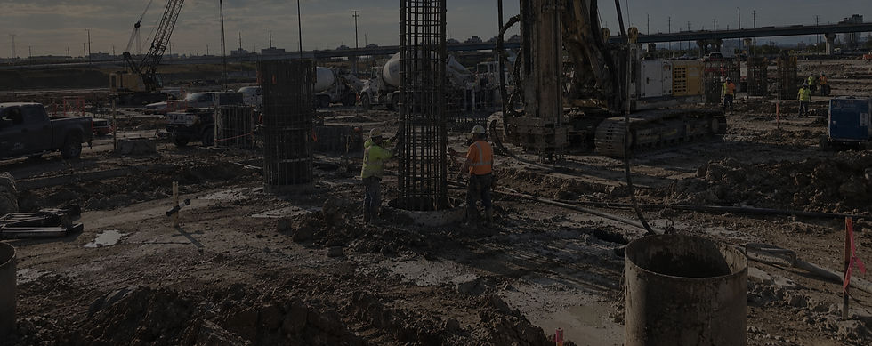 Drilling rig, reinforcing cages and steel casing at a foundation construction site