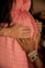 Pregnant woman and husband with and on belly