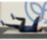 person on back doing core exercises at Align Functional Fitness