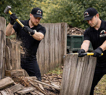 Light demolition crew tearing down damaged wood fencing and hauling away fence debris from a residential property in Henderson, NV near Green Valley and Seven Hills.