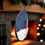 Thumbnail: Red Herd Groyne Lighthouse decoration hanging on a Christmas tree with festive lights.
