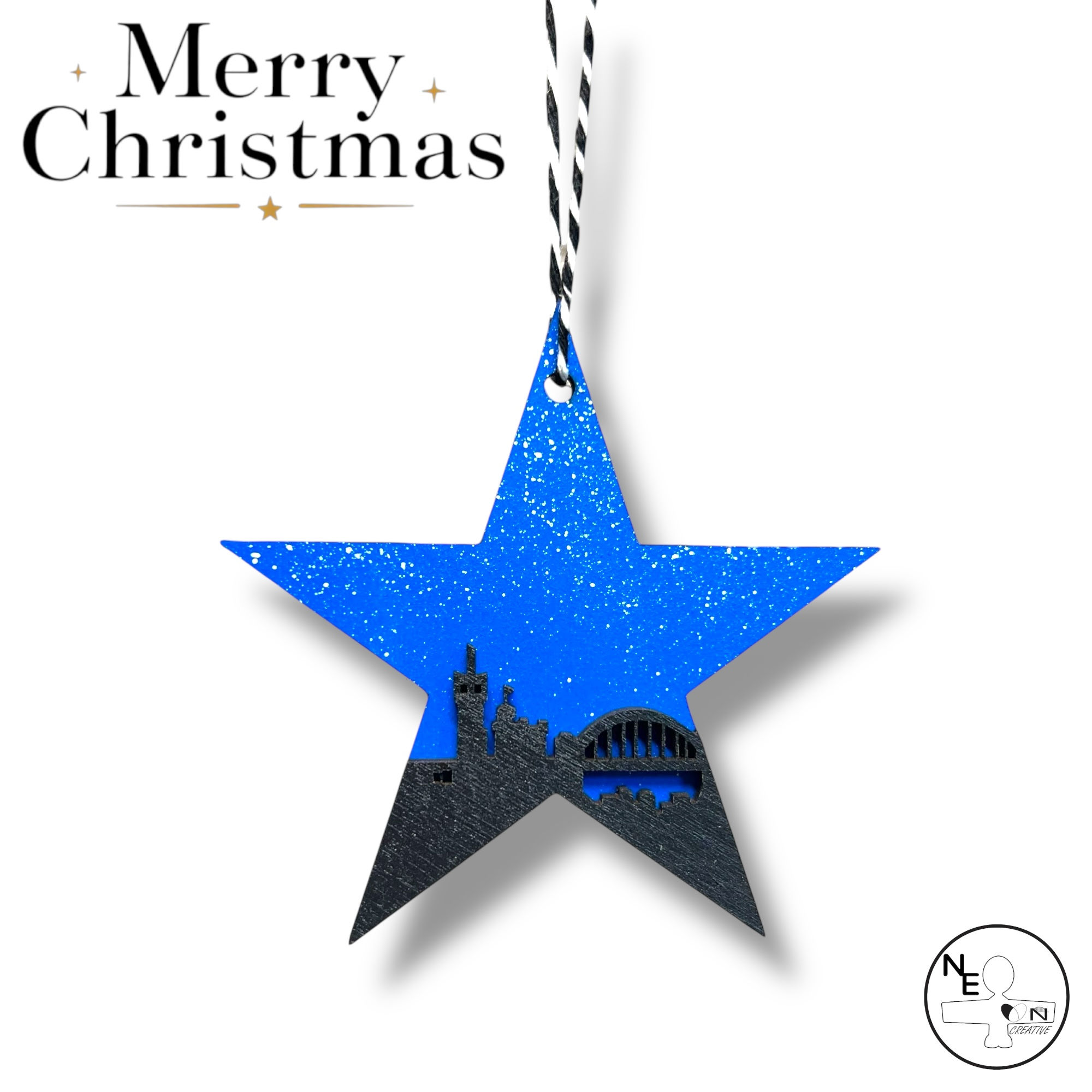 Hand painted Geordie Christmas Newcastle Blue Star  bauble with snowy night sky backdrop.
