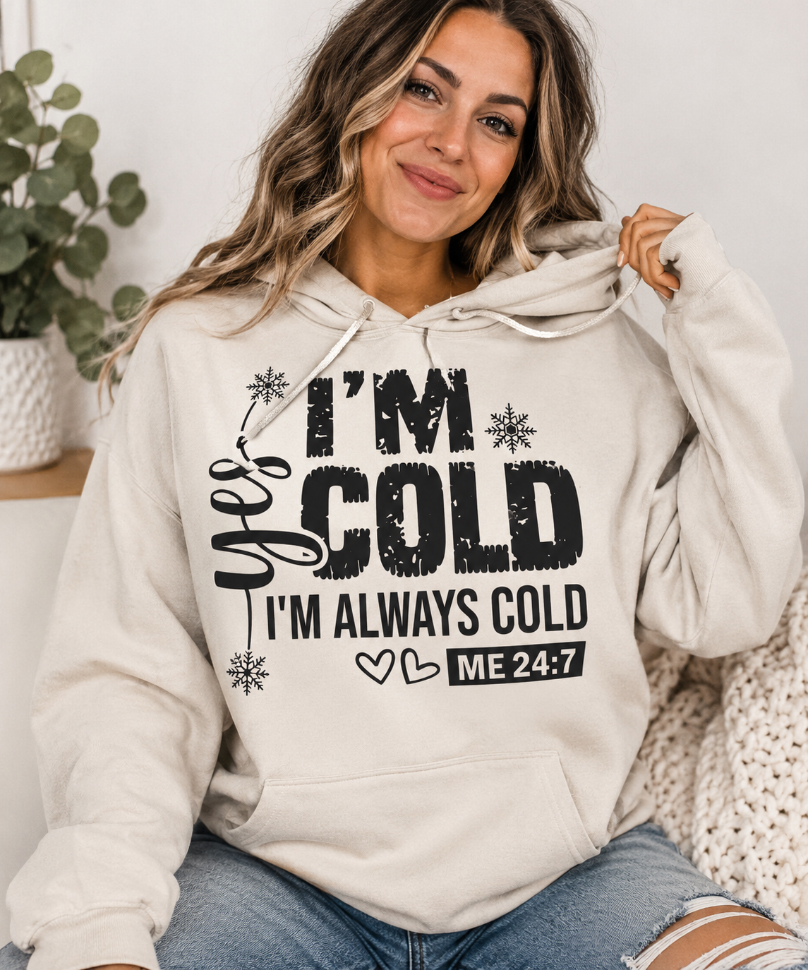Woman wearing an I’m Cold crewneck sweatshirt with snowflake design and I’m Always Cold message