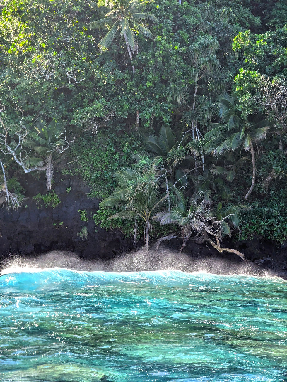 A small ocean wave crashing against Tahiti shore.