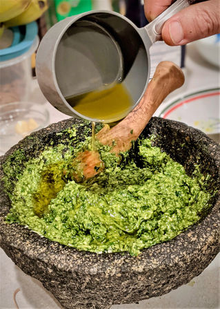 Adding oil to pesto