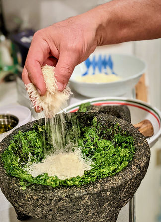 Adding cheese to pesto
