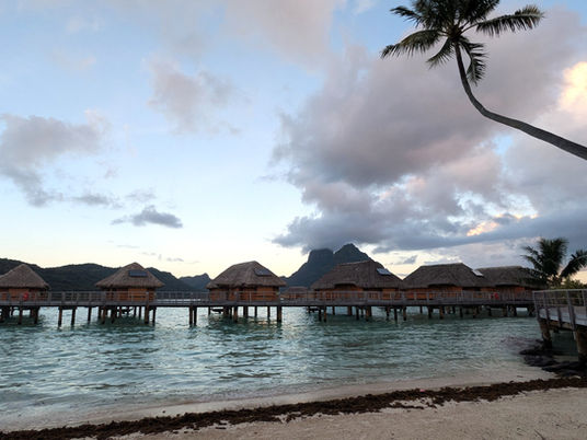 Overwater huts adorn the Bora Bora shore.