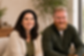 Co-founders Kelly & Jeremy smiling side by side in warm, neutral-toned business casual, set against a soft, minimal studio background.