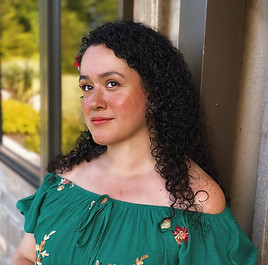 A woman with dark hair and a green dress.