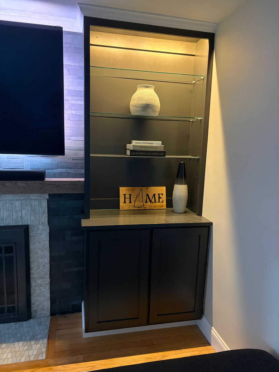 Custom built in with lighting and custom wood mantle