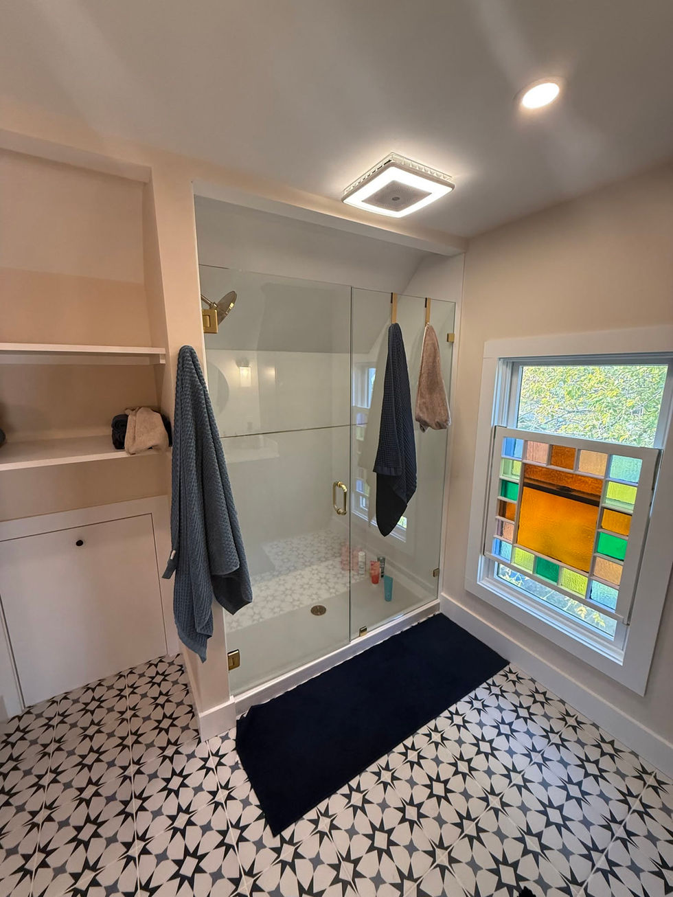 Bathroom remodel with custom tile installation and custom window installation.