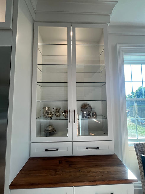Custom built-in cabinetry with wood countertop