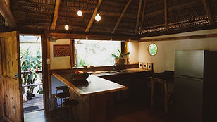 view from thelivingroom to the kithchen and outside to the garden at fare bungalow