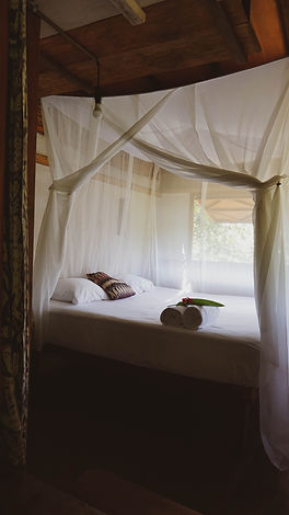 comfortable bed in our open bungalow with 2 windows and moskitonet