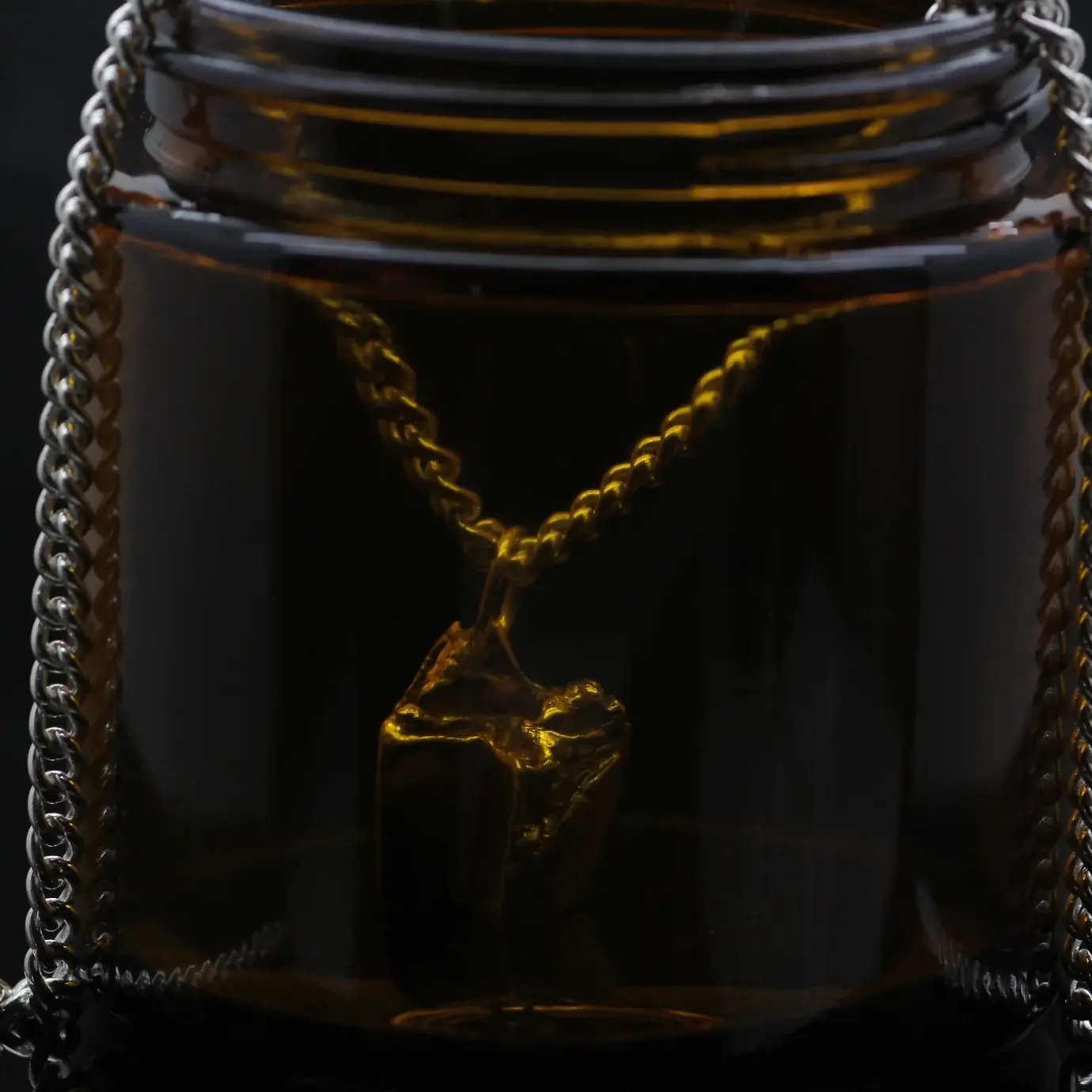 Sheep Tooth Cast silver Pendant jewellery in amber jar