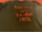 Green t-shirt with faith quote written in red letters