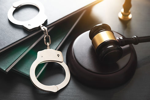 Handcuffs and wooden gavel. Crime and vi