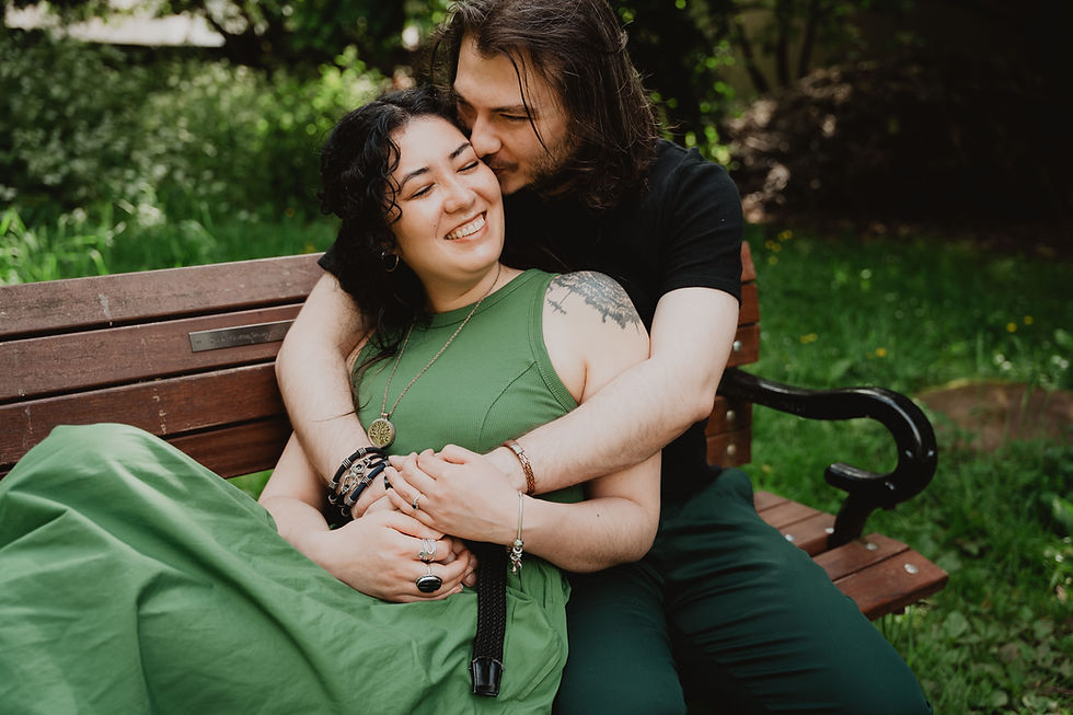 Suki & Sam sitting on a bench cuddling | Clifton Engagement Shoot | Cate Alldred Photograpy