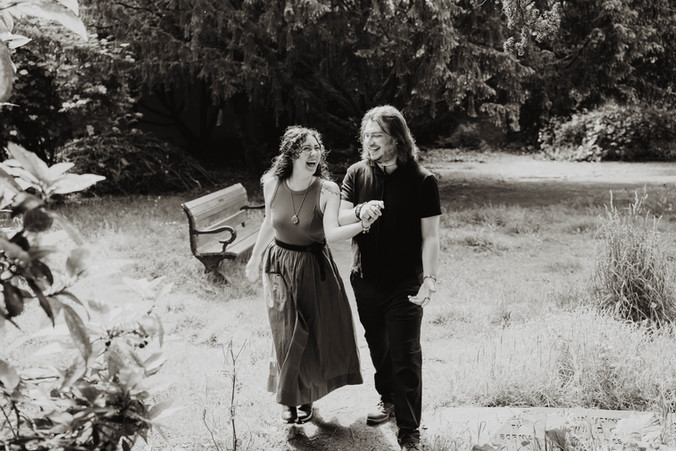 Couple cuddling and walking in Clifton gardens | Bristol Wedding Photographer