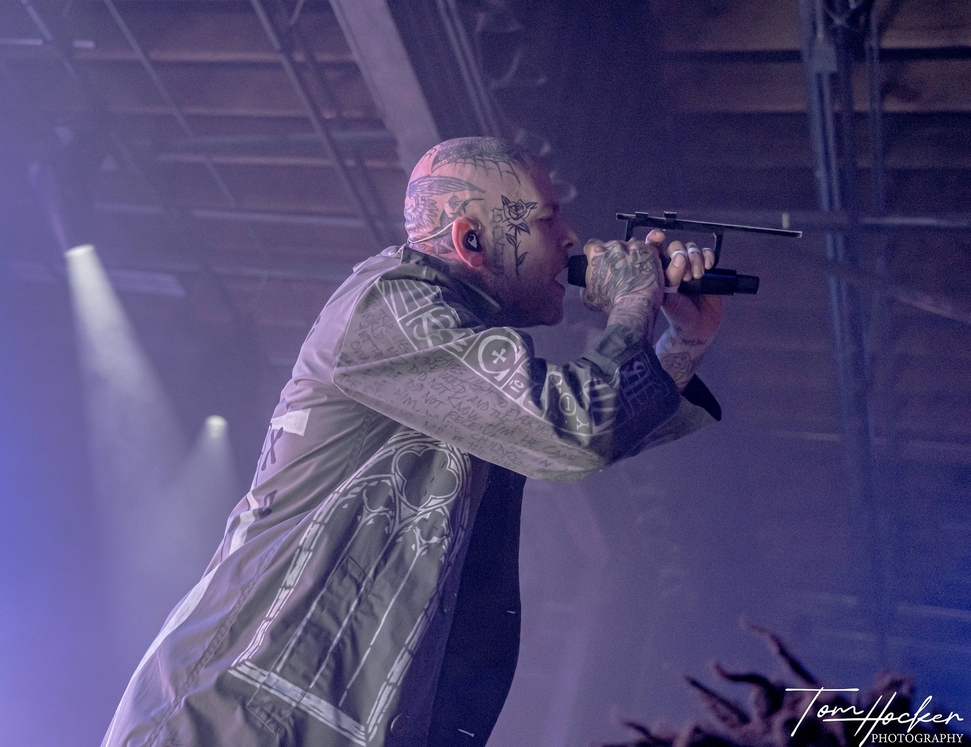 Ryan Clark of Demon Hunter singing to the crowd leaning forward