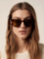 Woman wearing brown tortoiseshell sunglasses