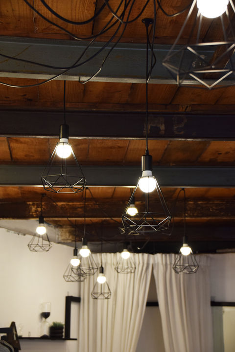 Exposed ceiling beams with hanging lightbulbs
