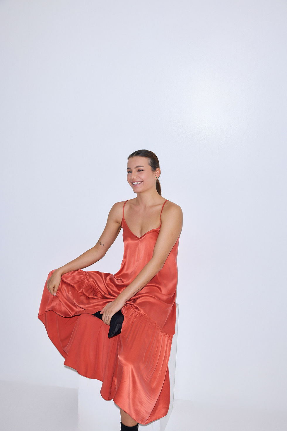 Thumbnail: Smiling woman in red silk dress