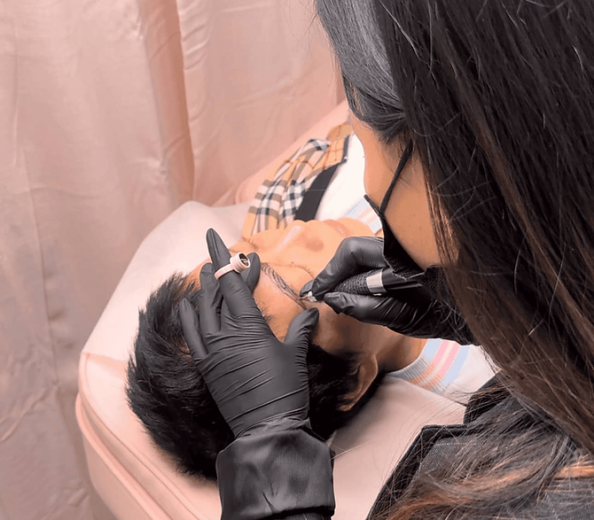 Professional cosmetic artist Kalie tattoos her client's eyebrows in Kalie's Brows & Beauty.
