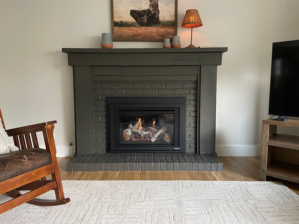 Lit fireplace with rocking chair in a living room