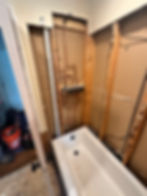 Bathroom renovation with new tub and exposed plumbing