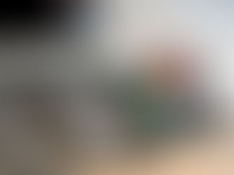 A man lying on his back under a chevron blanket, practicing breathwork.