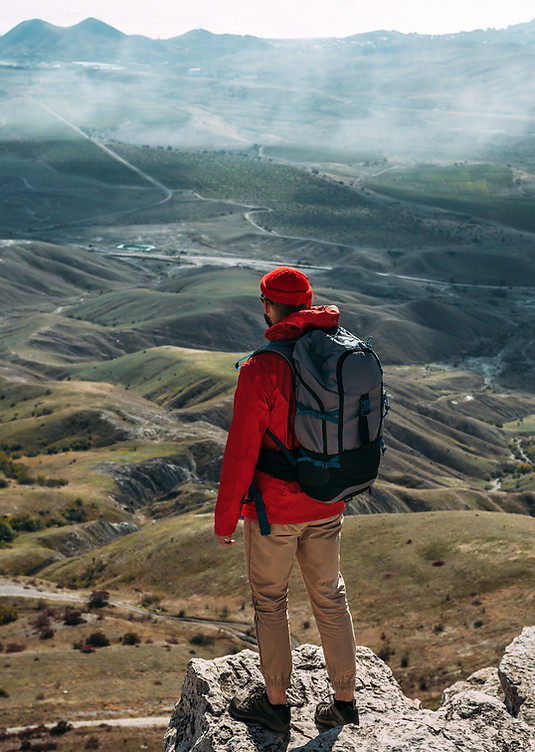 a-traveler-on-the-background-of-mountains-a-touri-2022-02-17-23-13-22-utc.jpg