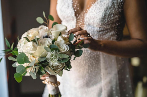 Bride wearing a wedding dress and holding her bouquet