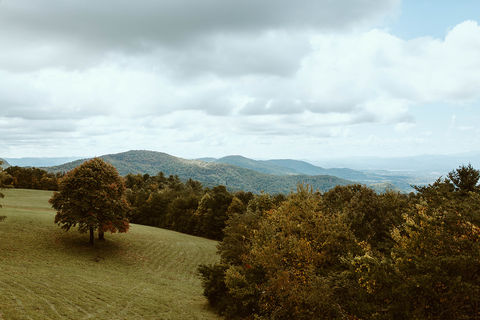 Rolling hills and Blue Ridge Mountain views from the back porch of Cabin Heaven wedding venue in North Carolina.