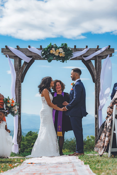 Couple and officiant getting married in NC Mountains