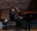 Piano student performing on stage during a concert at Elite Piano Institute