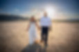 Newlywed couple walking through the desert