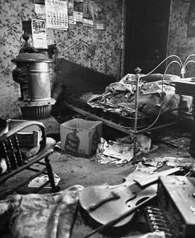 The filthy, cluttered bedroom of Ed Gein. Gein boarded up rooms used by his mother, leaving them untouched and pristine as the rest of the house became increasingly squalid.