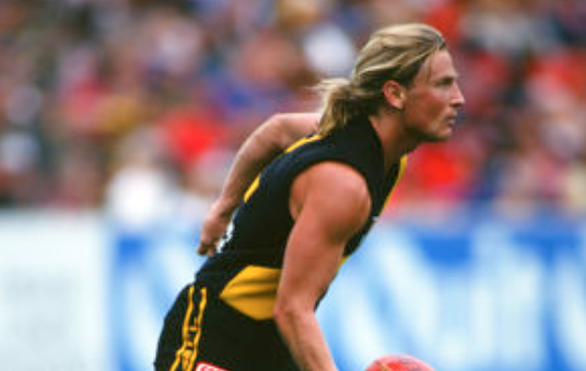 Matthew Dundas gets a handball away against the Dockers.