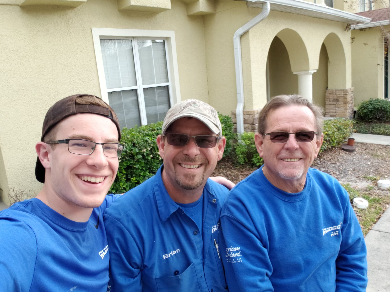 Hudson Air family members in company shirts, from a photo on the company website